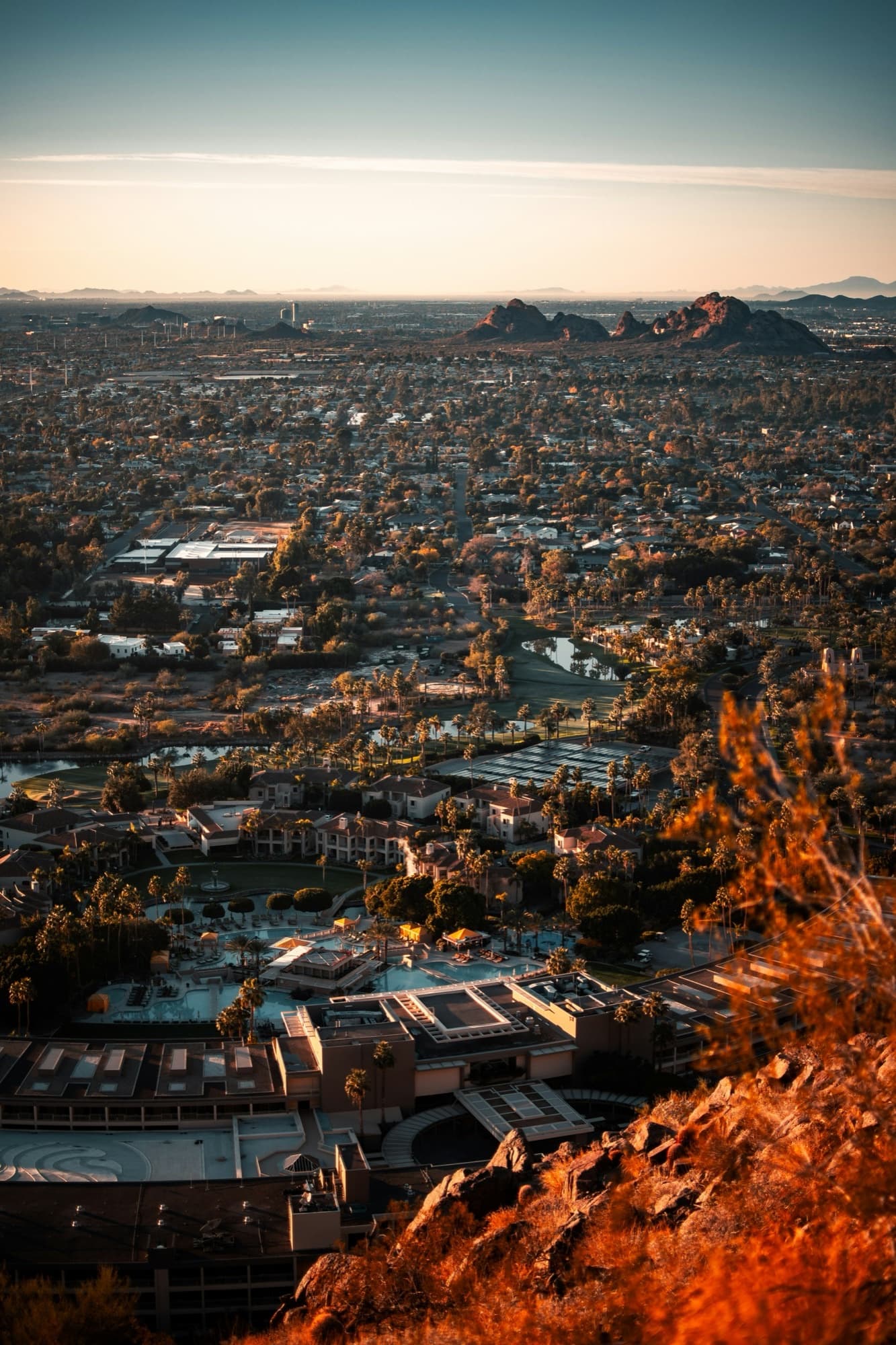 An aerial view at sunset across a wide expanse of American suburban housing